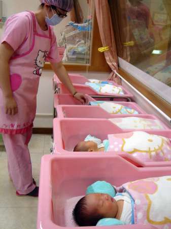 A nurse tends to a baby inside a Hello Kitty themed maternity ...